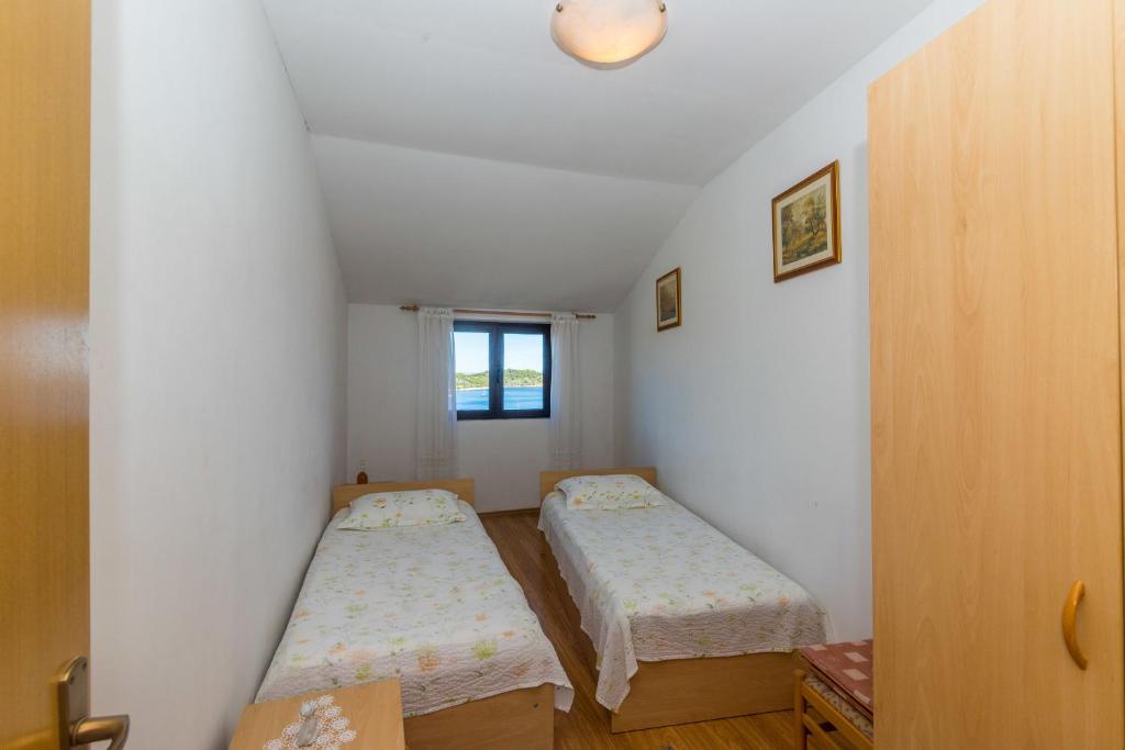 Postel nebo postele na pokoji v ubytování Apartments Jaksa
