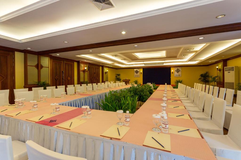 a large conference room with a long table and white chairs at Prince Angkor Hotel & Spa in Siem Reap