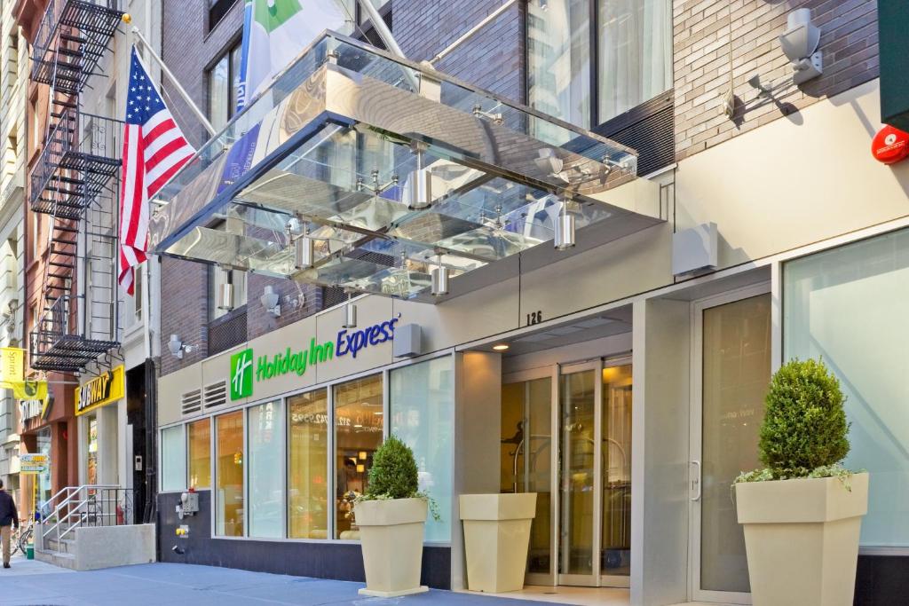 una tienda frente a un edificio con una bandera americana en Holiday Inn Express - Wall Street, an IHG Hotel en Nueva York