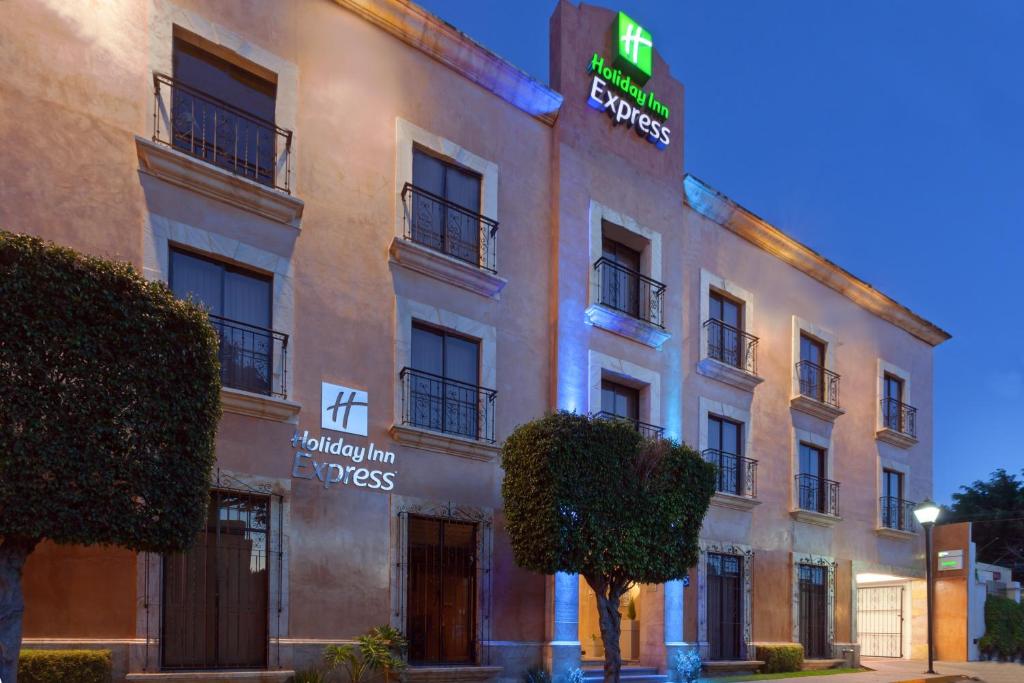 a building with a sign on the side of it at Holiday Inn Express Oaxaca - Centro Historico by IHG in Oaxaca City