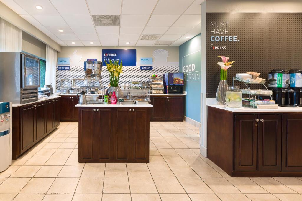 a coffee shop with a counter with flowers on it at Holiday Inn Express San Jose Costa Rica Airport by IHG in Alajuela City