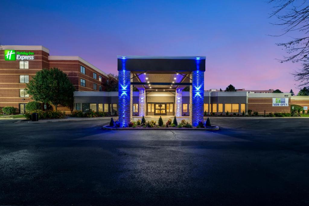a building with blue columns in front of a building at Holiday Inn Express Naperville, an IHG Hotel in Naperville