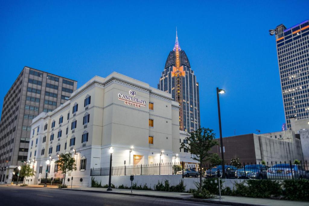 a tall building with a clock on the side of it at Candlewood Suites Mobile-Downtown, an IHG Hotel in Mobile