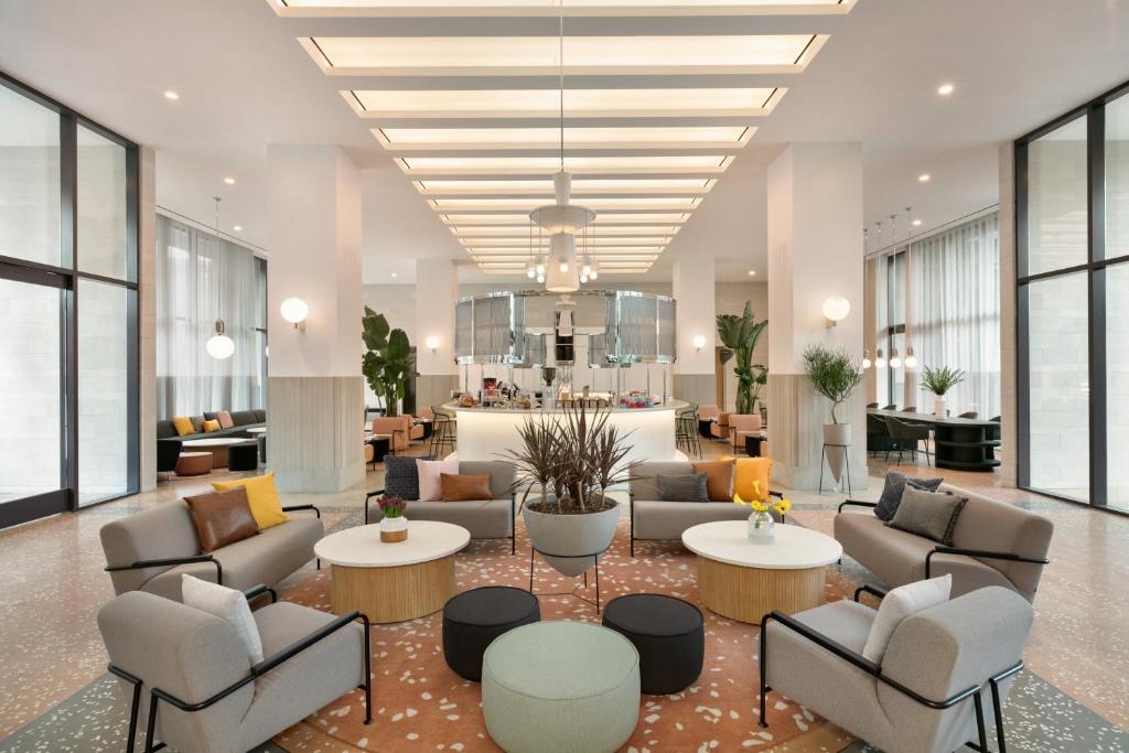 a lobby with couches and tables in a building at Hotel Indigo - Williamsburg - Brooklyn, an IHG Hotel in Brooklyn