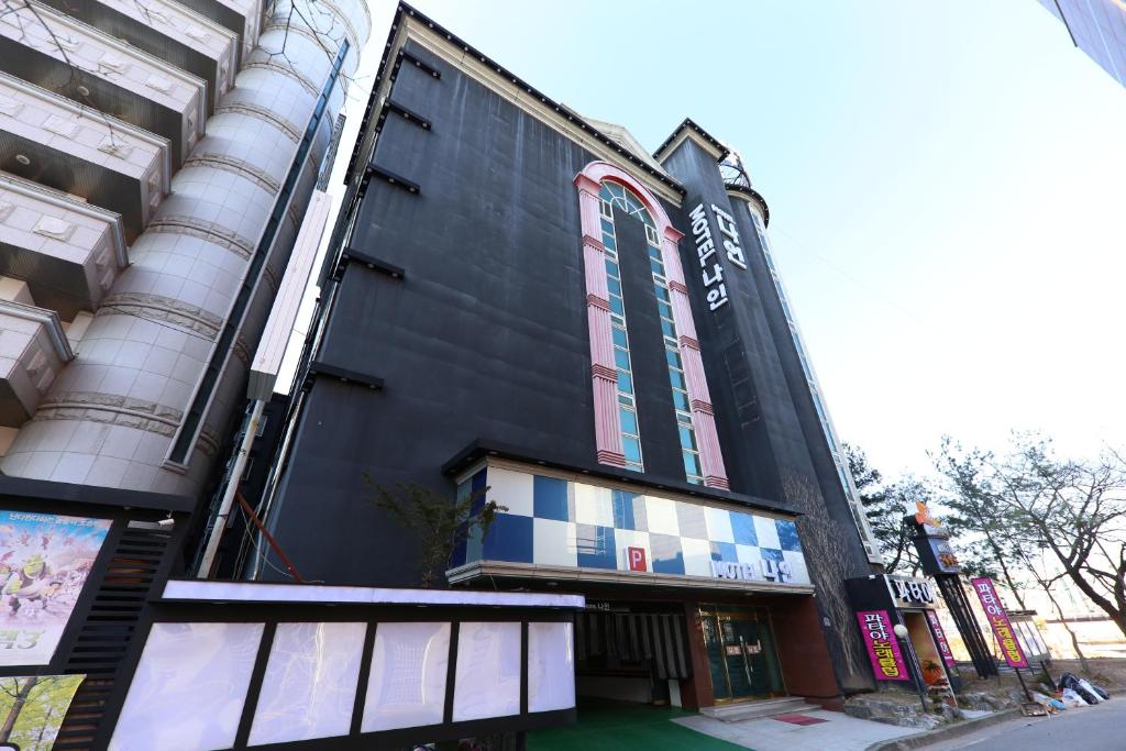 a black building with a window on a street at Motel Nine in Daejeon