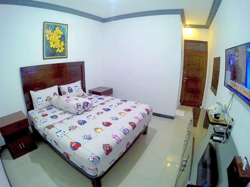 Postel nebo postele na pokoji v ubytování Amaryllis Guesthouse Syariah
