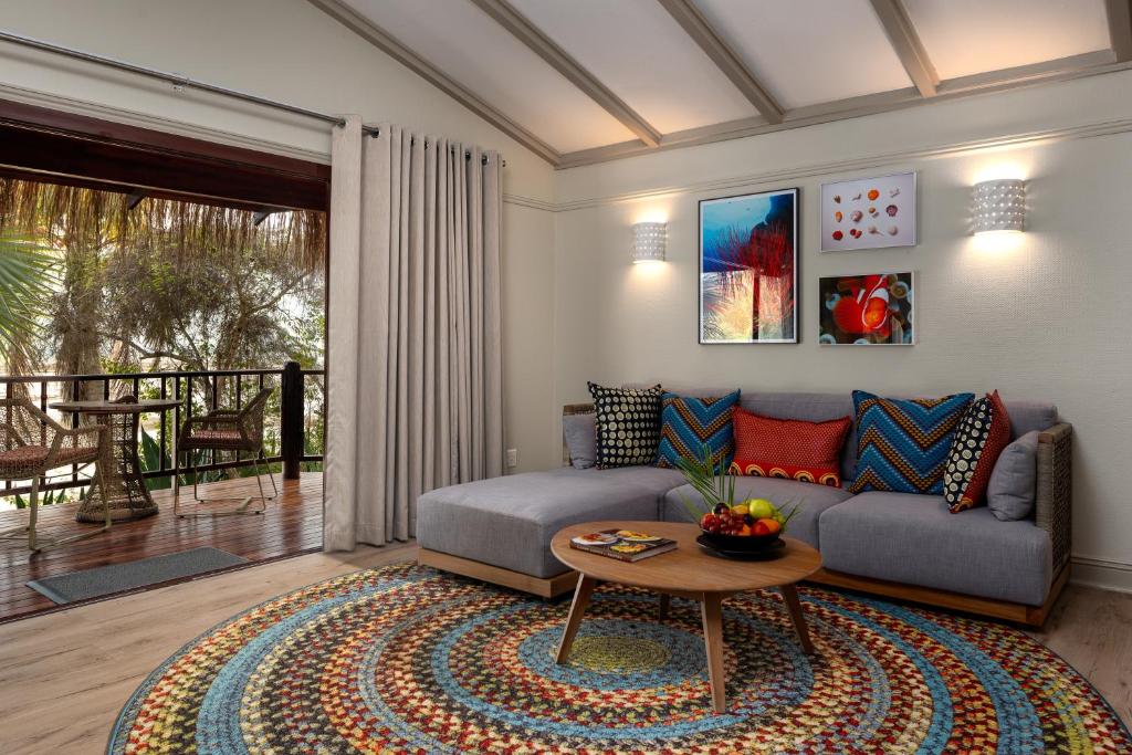 a living room with a couch and a table at Anantara Bazaruto Island Resort in Bazaruto