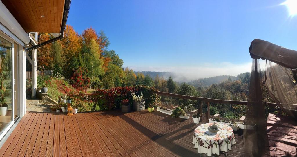 - Terraza con mesa y vistas a la montaña en Komfortowy Dom w Chmurach, en Dydnia