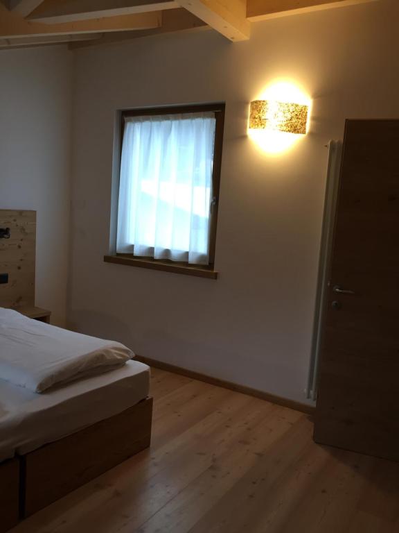 Posteľ alebo postele v izbe v ubytovaní MOUNTAIN RESORT Appartamenti