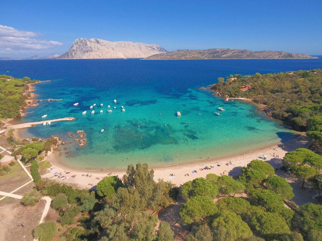 an aerial view of a beach with people in the water at Futura Club Baja Bianca in San Teodoro