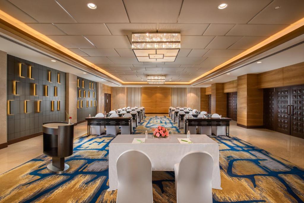 a conference room with a long table and chairs at Holiday Inn Agra MG Road an IHG Hotel in Agra