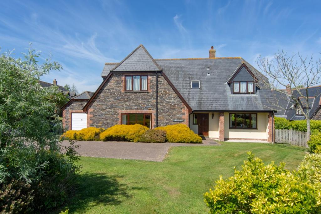 a large brick house with a yard at Webbs Retreat in Wadebridge