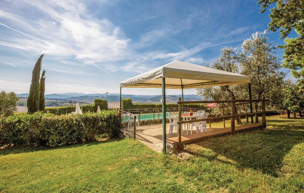 a pavilion with a table and chairs in a yard at Agriturismo Mannaioni in Volterra