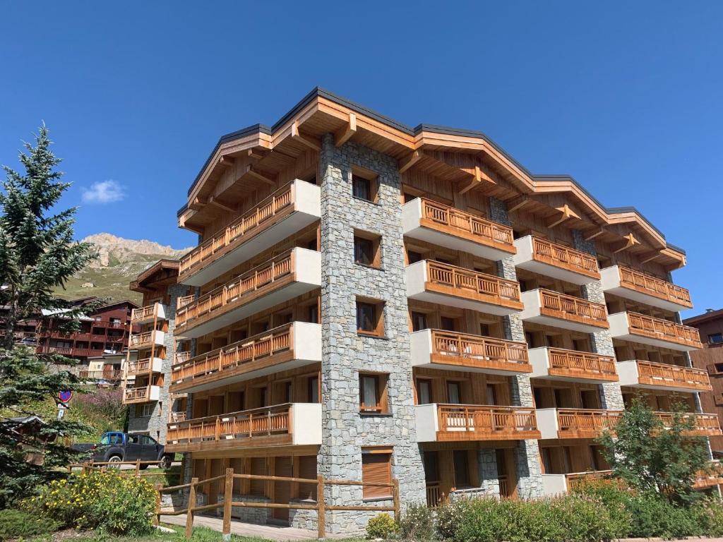 a tall apartment building with balconies on it at Edelweiss 2100 in Tignes