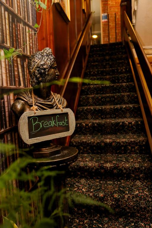 a staircase in a library with a sign that reads break least at Avarest House BB Adults Only in Portrush