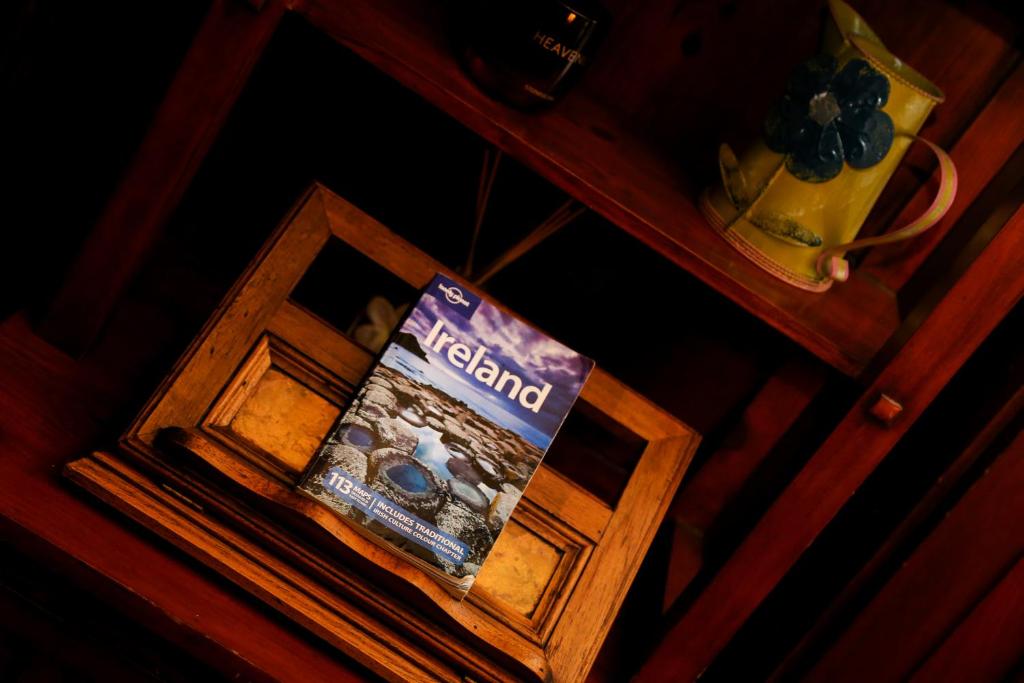 a book sitting on top of a wooden table at Avarest House BB Adults Only in Portrush