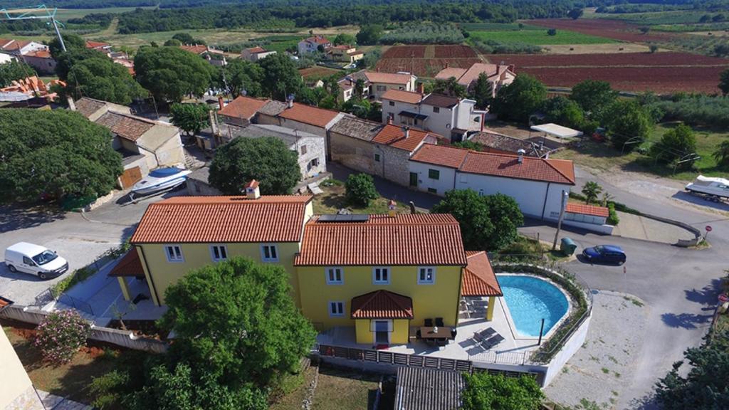 an aerial view of a house with a pool at Complex of 2 villas Mugeba III with 2 private pools for up to 16 persons in Porec near the Aquapark in Mugeba