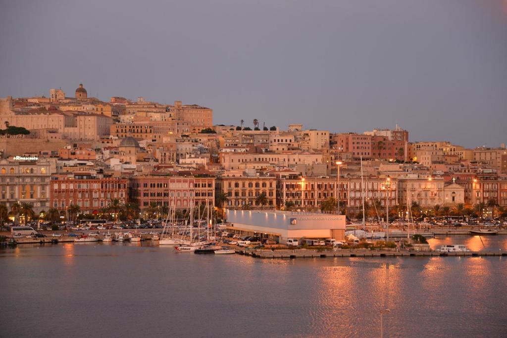 a view of a city with boats in a harbor at Palazzo Doglio in Cagliari