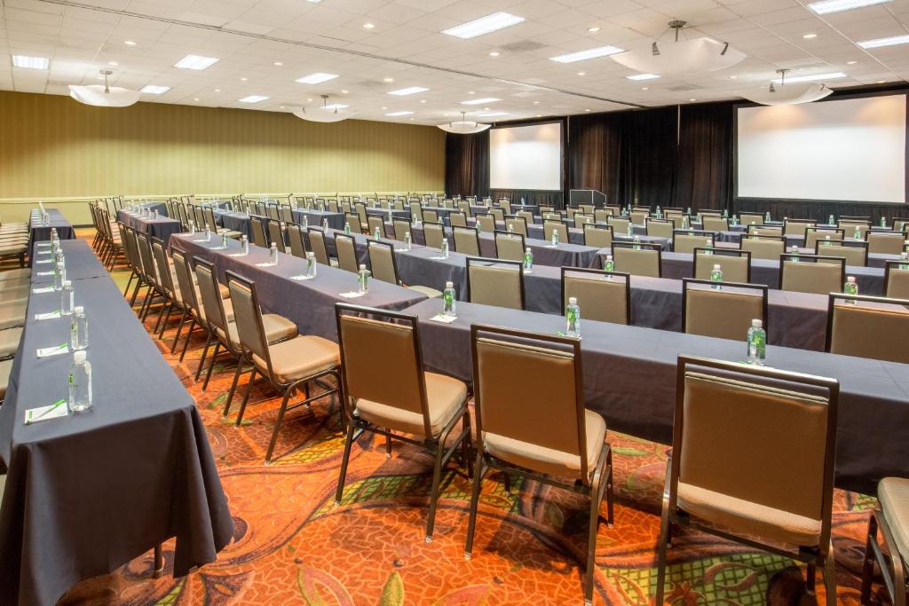 a conference room with rows of tables and chairs at Holiday Inn Portland-Airport I-205, an IHG Hotel in Portland