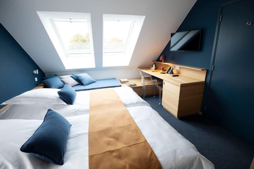 Postel nebo postele na pokoji v ubytování B-Lodge Boutique Hôtel