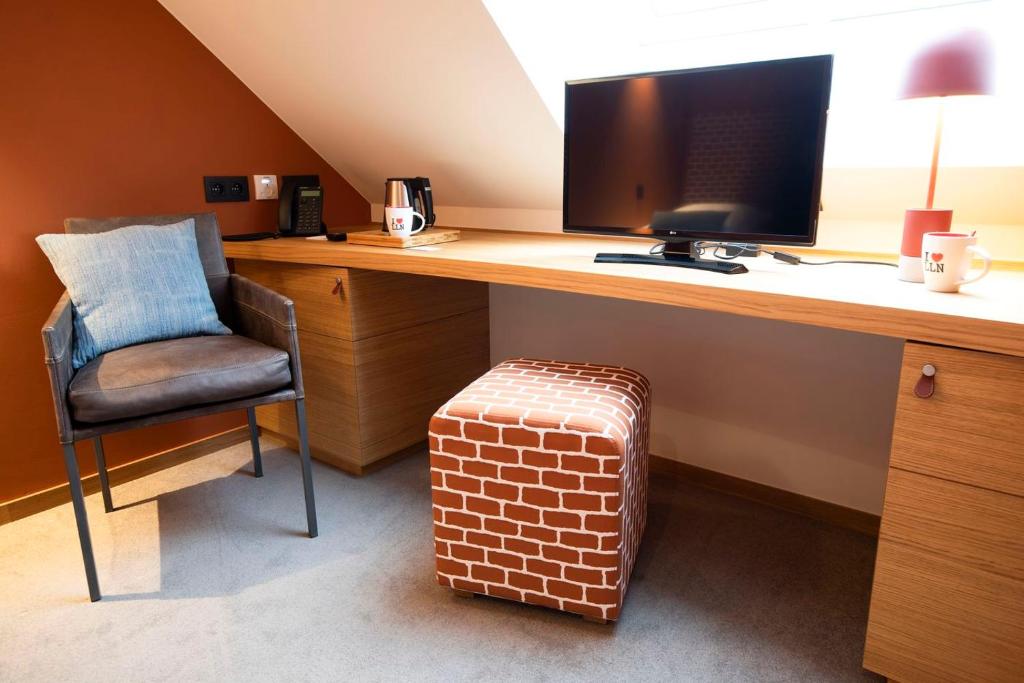 TV a/nebo společenská místnost v ubytování B-Lodge Boutique Hôtel