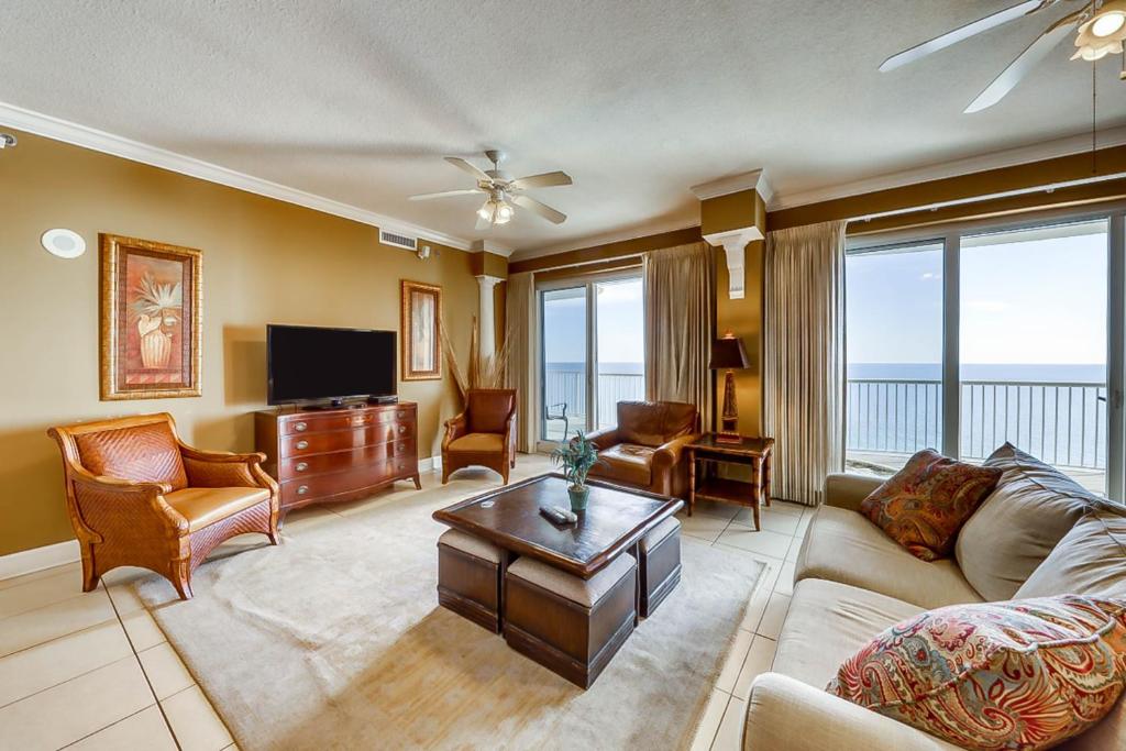 a living room with a couch and a tv at Island Royale in Gulf Shores