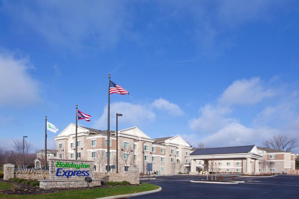 a building with two american flags in front of it at Holiday Inn Express - Columbus - Dublin, an IHG Hotel in Dublin