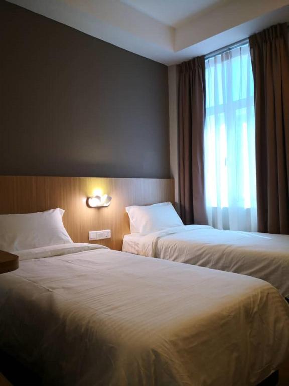 Postel nebo postele na pokoji v ubytování Walk In Hotel