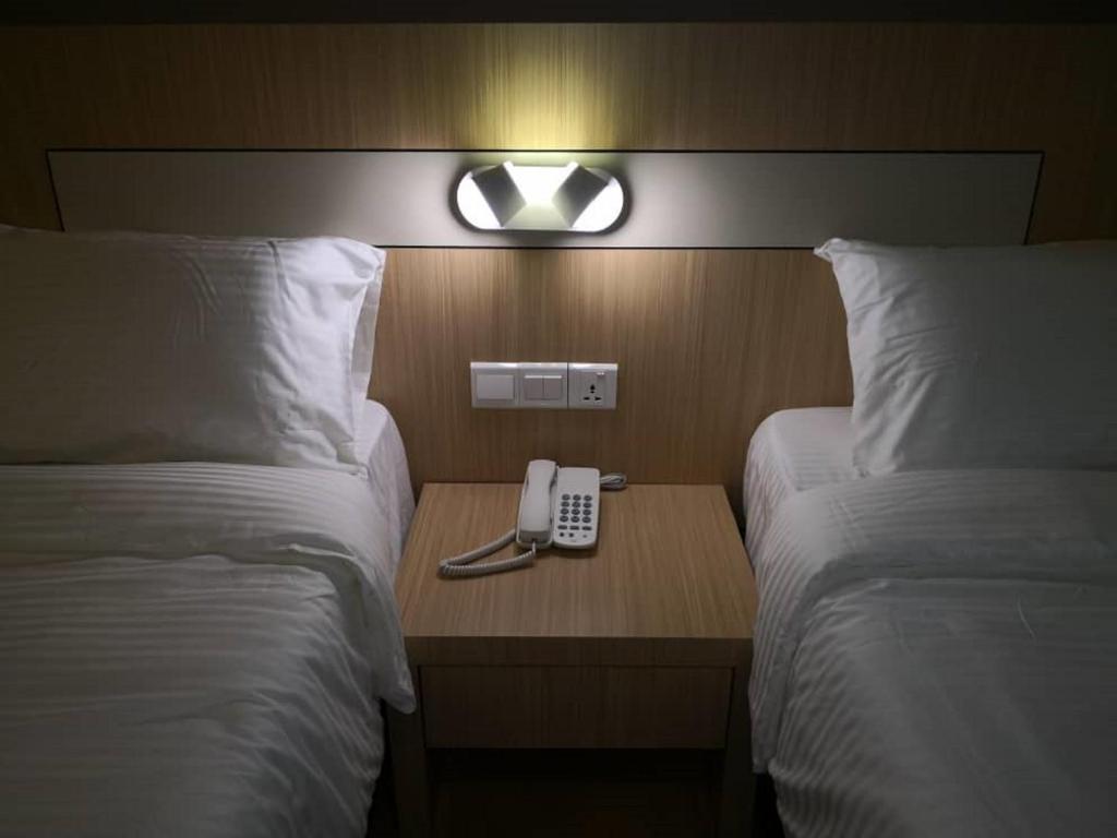 A bed or beds in a room at Walk In Hotel