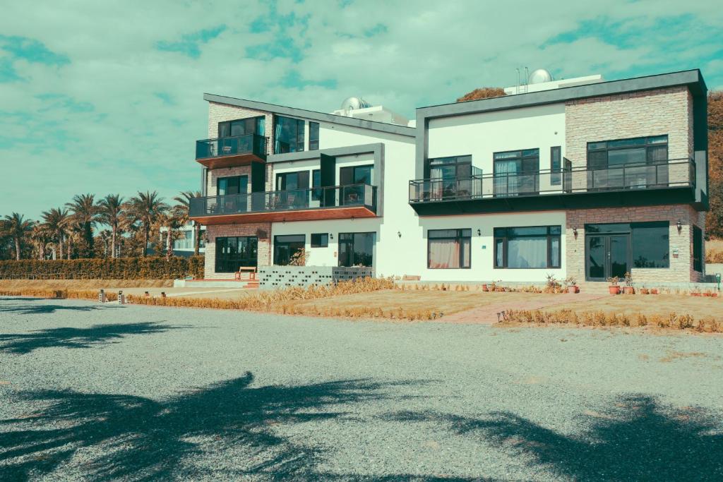 a large white building on the side of a street at Shark B&B in Hengchun