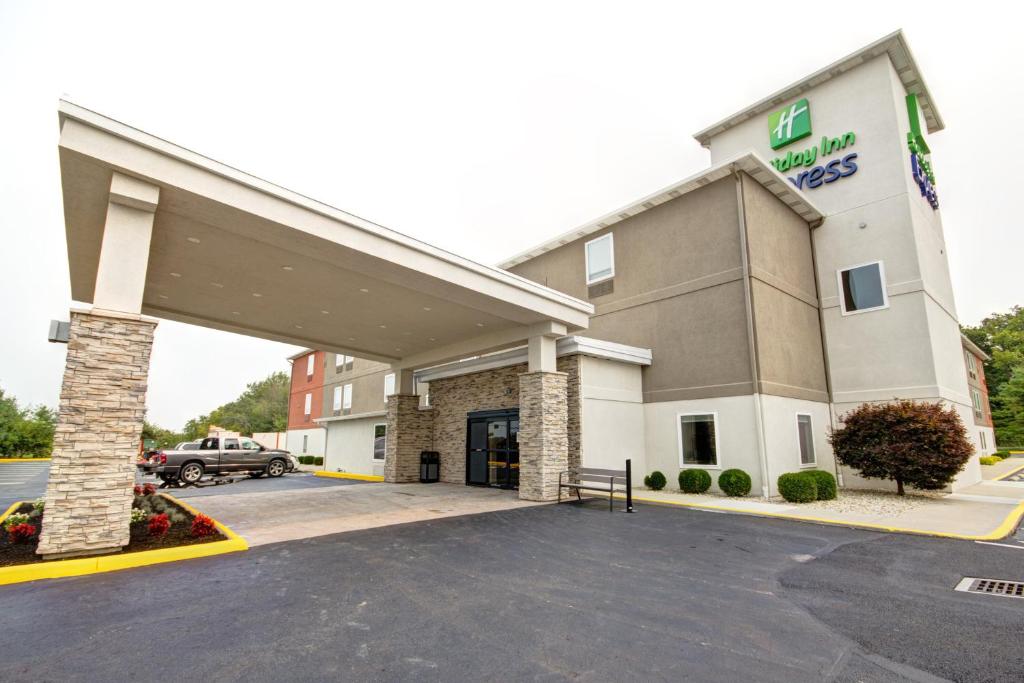 a hotel building with a car parked in a parking lot at Holiday Inn Express Columbus South - Obetz, an IHG Hotel in Obetz