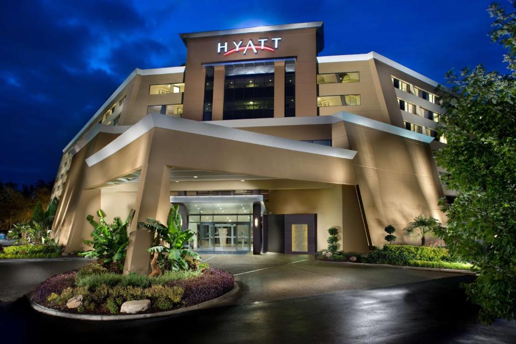 a large building with a sign on it at night at Hyatt Regency Suites Atlanta Northwest in Atlanta