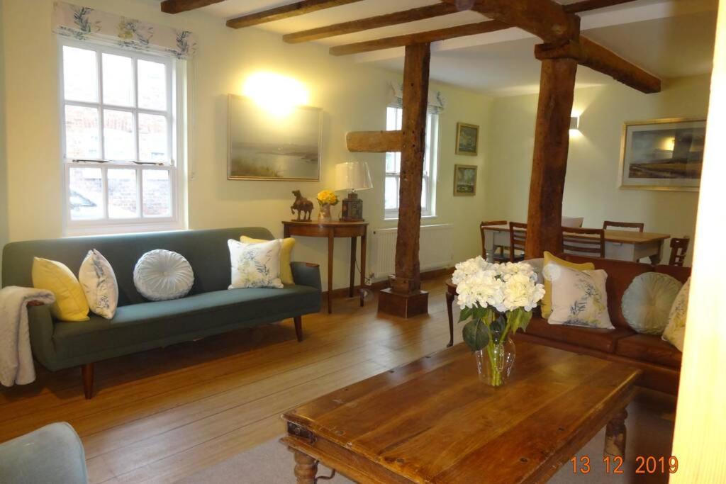 a living room with a couch and a coffee table at Lovely old cottage in Stratford-upon-Avon