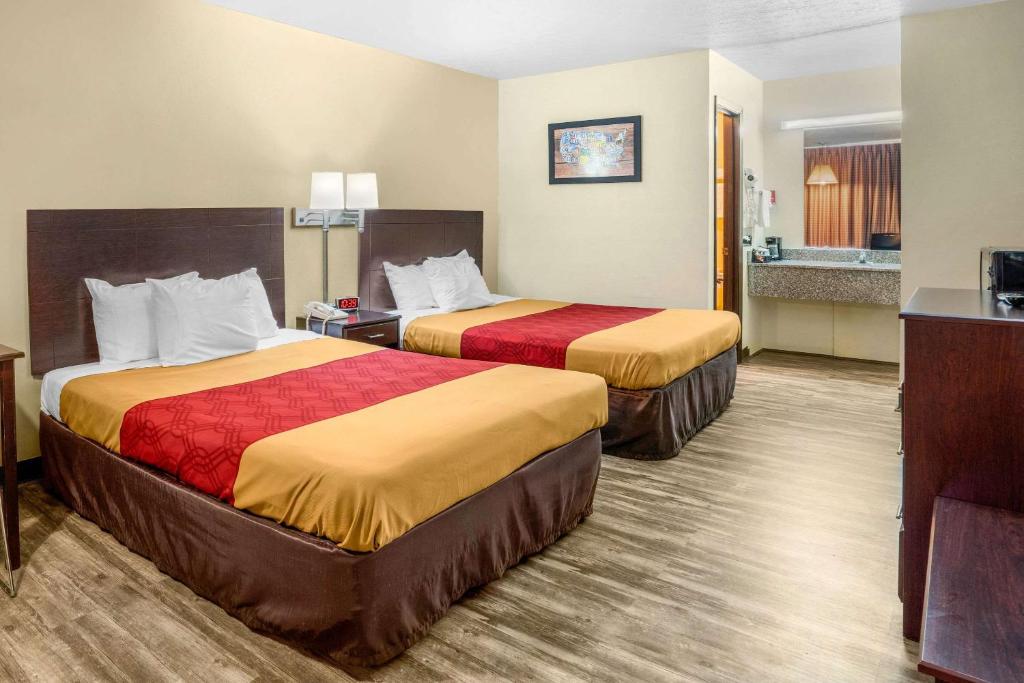 Habitación de hotel con 2 camas y baño en Econo Lodge near Missouri University of Science and Technology, en Rolla