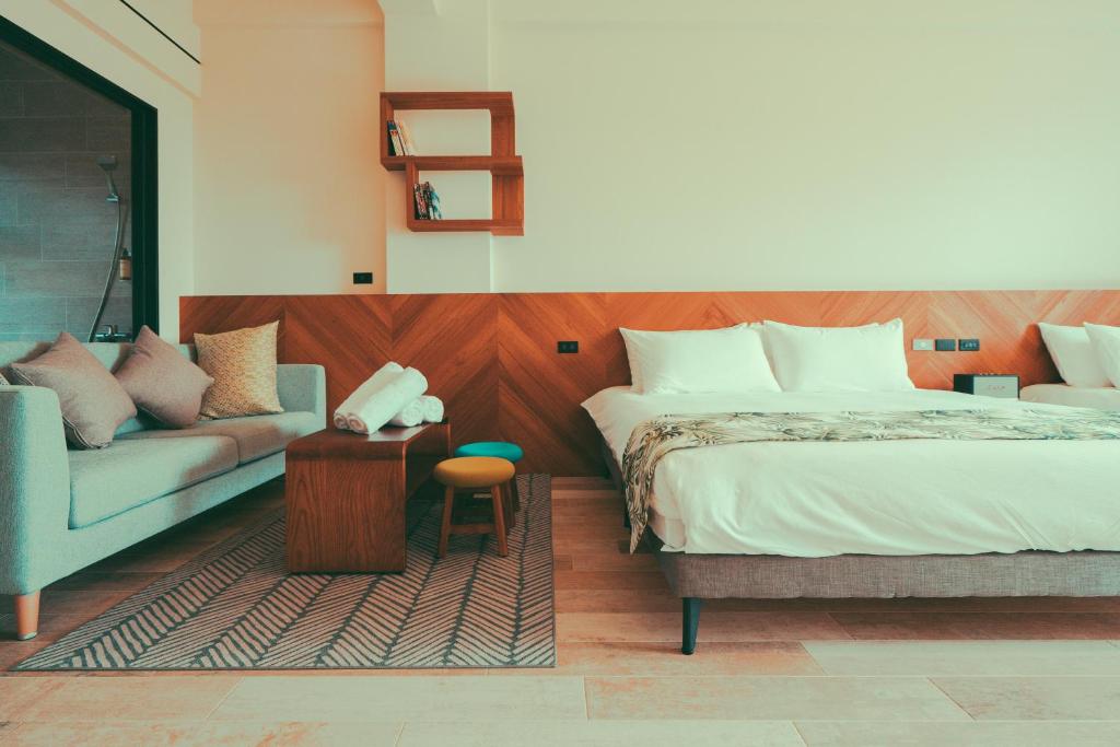 a bedroom with a bed and a couch at Shark B&B in Hengchun