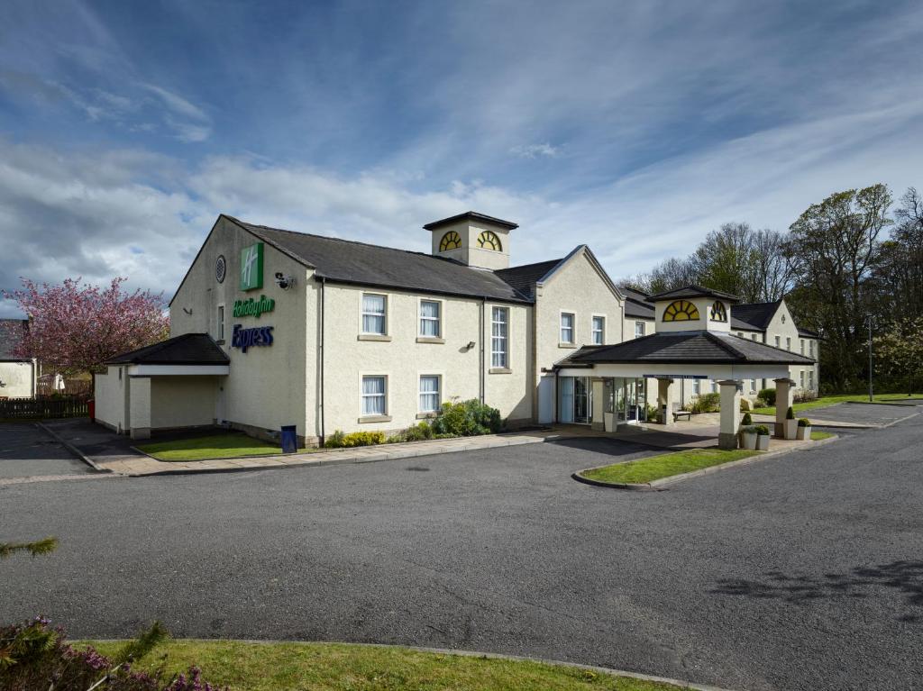 un grand bâtiment blanc avec une tour d'horloge en haut dans l'établissement Holiday Inn Express Glenrothes, an IHG Hotel, à Glenrothes