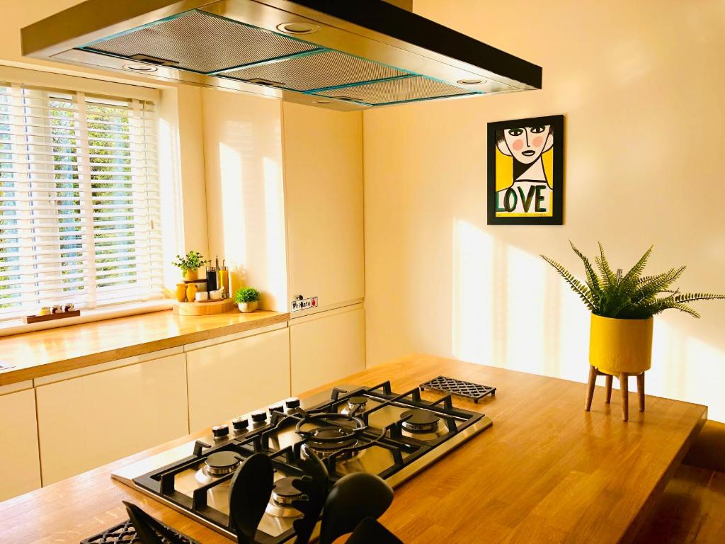 a kitchen with a stove top oven in a room at The Duplex Margate with Deck & Living Space Air Conditioning in Margate