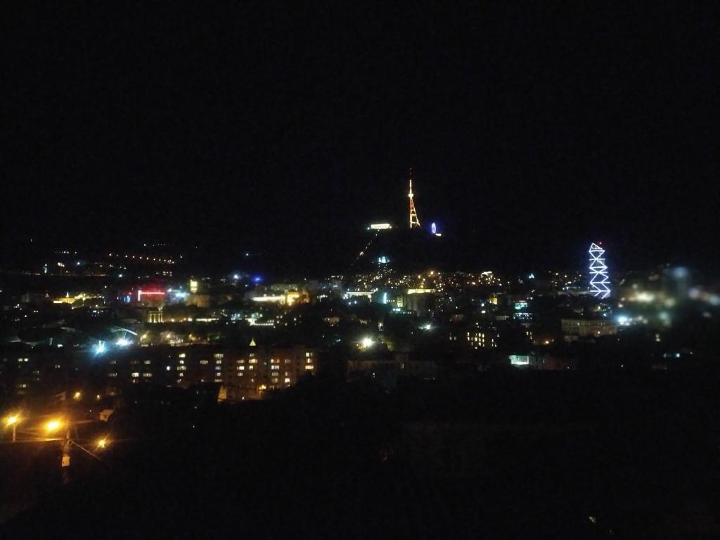 uma vista para uma cidade à noite com luzes em ANAs House em Tbilisi