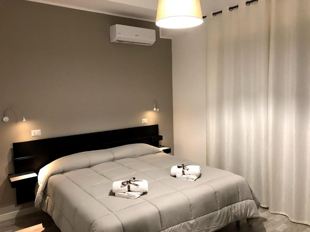 a bedroom with a bed with two towels on it at La Maison in Acquaviva delle Fonti