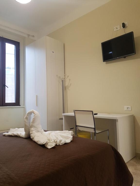 sypialnia z łóżkiem, biurkiem i telewizorem w obiekcie Hotel Emmy w Mediolanie