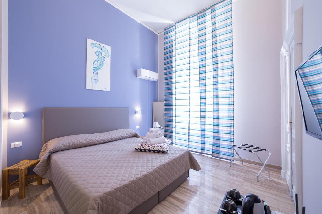 a bedroom with a bed and a large window at PC Boutique H Loggia, by ClaPa Group in Naples