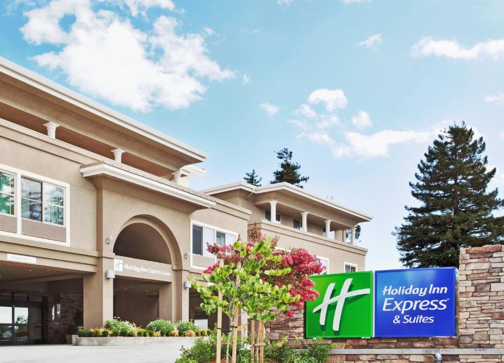 a hilton inn express and suites sign in front of a building at Holiday Inn Express Hotel & Suites Santa Cruz, an IHG Hotel in Santa Cruz