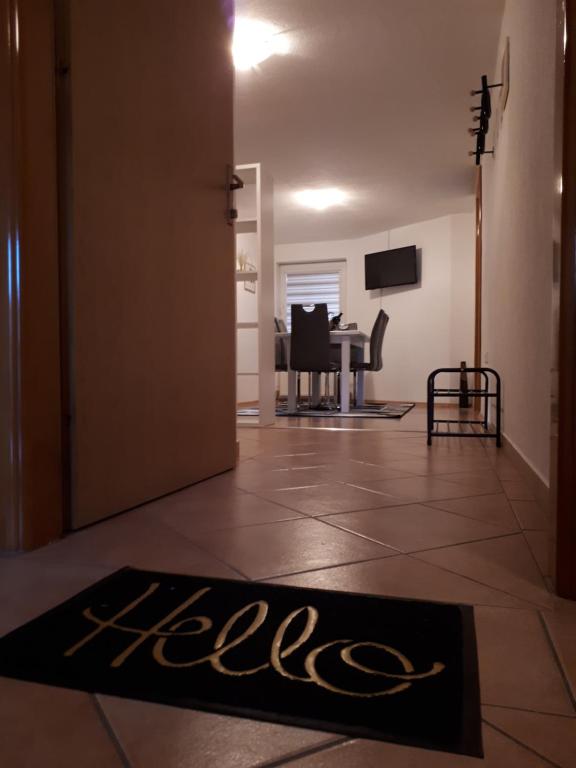a door leading into a living room with a rug on the floor at Apartman Ivana in Jajce