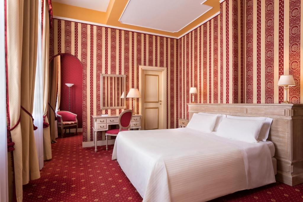 a bedroom with a large white bed in a room at Sina Palazzo Sant'Angelo in Venice