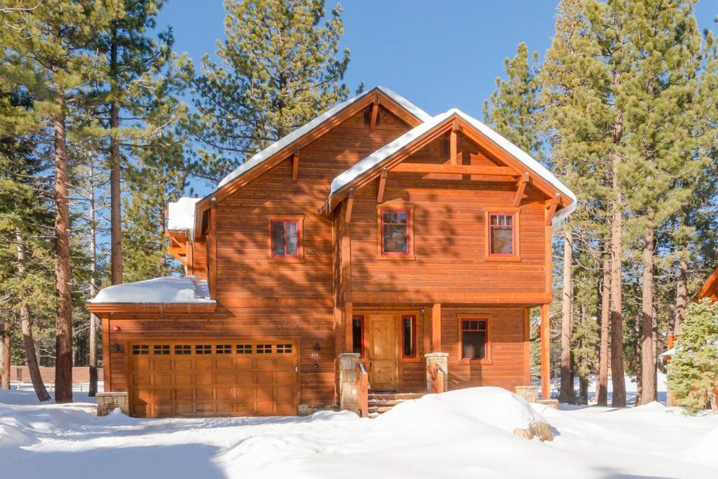 a log cabin in the woods in the snow at Gray Bear 454 in Mammoth Lakes