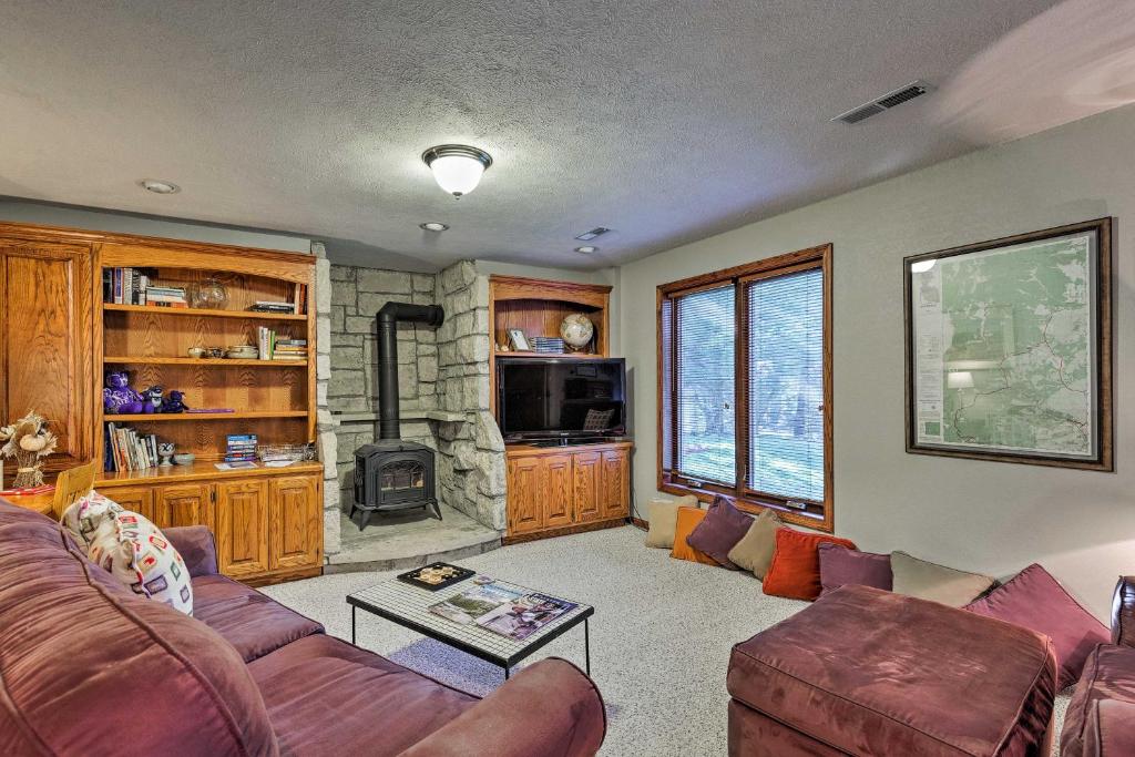 a living room with a couch and a fireplace at Charming Hideaway with Patio 3 Mi to Kansas State! in Manhattan