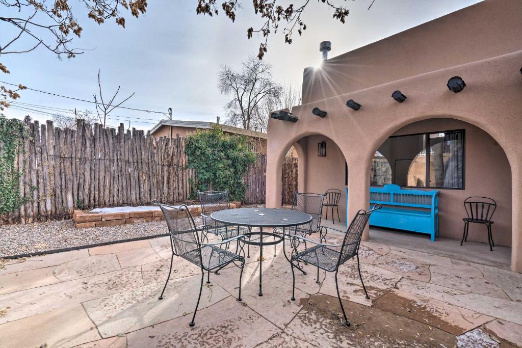 een patio met een tafel en stoelen en een hek bij Adobe House with Patio - Walk to Dtwn Plaza and Shops! in Santa Fe