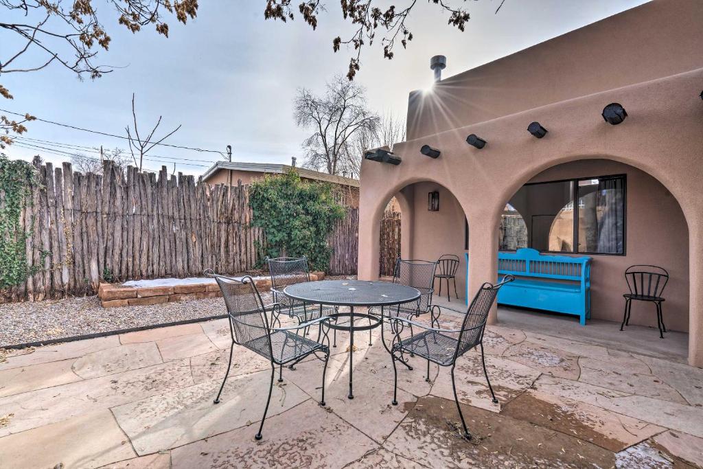 a patio with a table and chairs and a fence at Adobe House with Patio - Walk to Dtwn Plaza and Shops! in Santa Fe