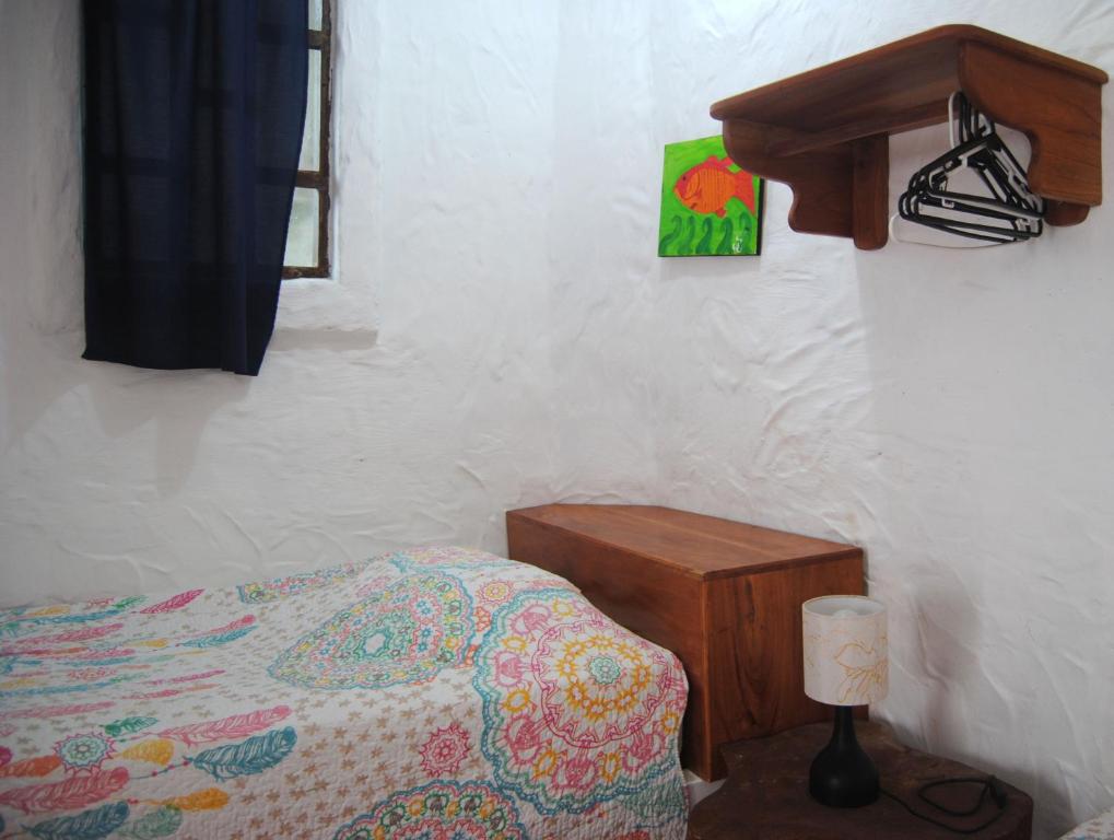 Postel nebo postele na pokoji v ubytování Hostal Galapagos by Bar de Beto