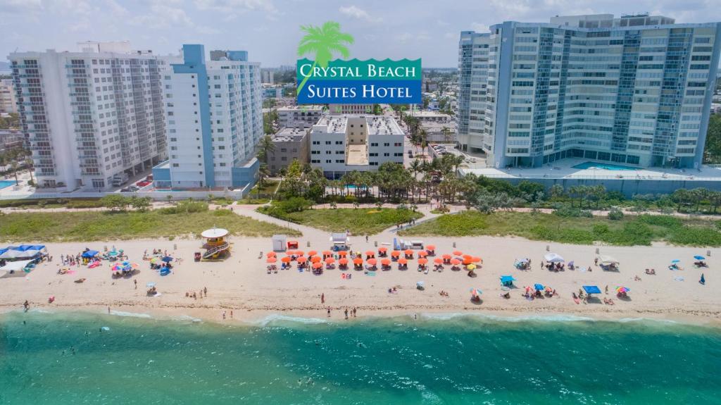 
a beach filled with lots of colorful umbrellas at Crystal Beach Suites Oceanfront Hotel in Miami Beach
